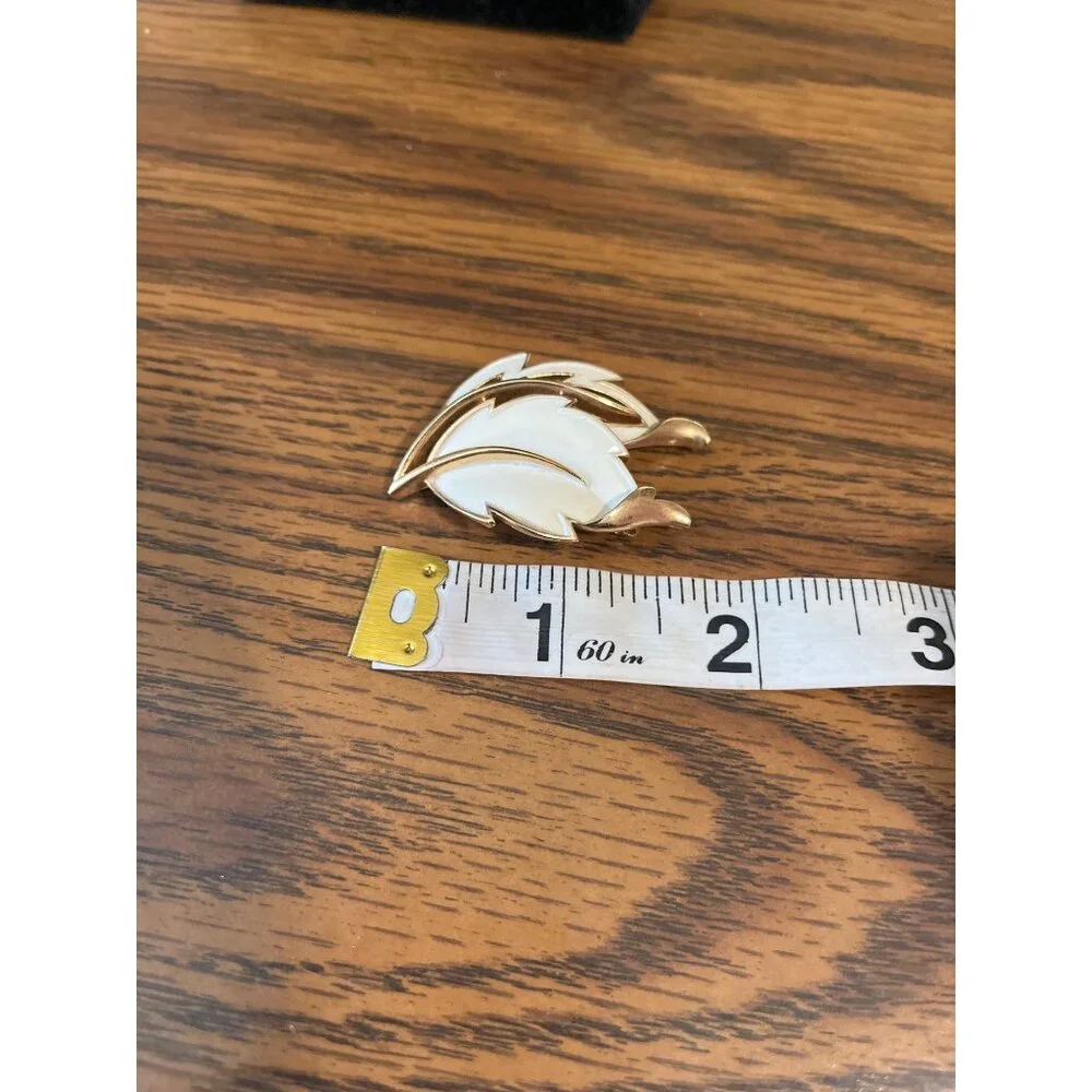 Crown Trifari gold tone and white enamel leaf design brooch